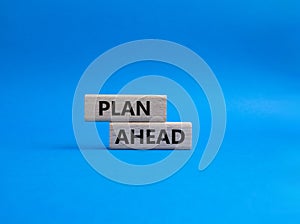 Plan ahead symbol. Wooden blocks with words Plan ahead. Beautiful blue background. Business and Plan ahead concept. Copy space