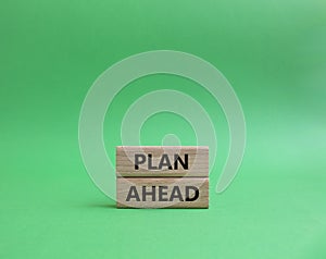 Plan ahead symbol. Wooden blocks with words Plan ahead. Beautiful green background. Business and Plan ahead concept. Copy spacÑƒ