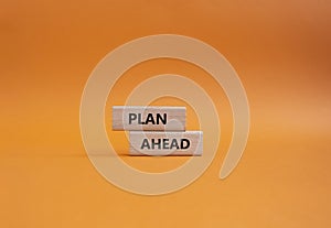 Plan ahead symbol. Wooden blocks with words Plan ahead. Beautiful orange background. Business and Plan ahead concept. Copy spa