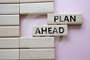 Plan ahead symbol. Wooden blocks with words Plan ahead. Beautiful pink background. Business and Plan ahead concept. Copy space