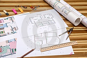 Plan of apartment rooms and blueprint rolls