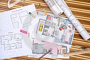 Plan of apartment rooms and blueprint rolls with work tolls photo