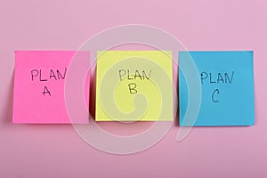 Plan a, plan b or plan c on colorful office stickers on pink background