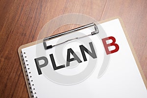 PLAN B text on white paper on the wood table