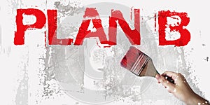 Plan B words in red and brush in hand on grundge white grey background. Crisis management business concept