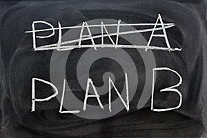 Plan A crossed out and Plan B written with a chalk on the blackboard photo