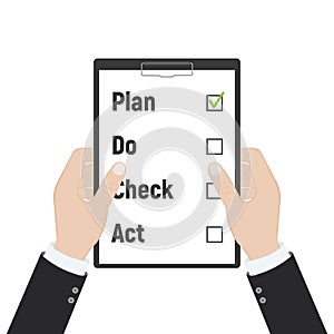 Plan Do Check Act. Businessman checks the action list holding clipboard in hand. Business concept. Action plan on paper. PDCA