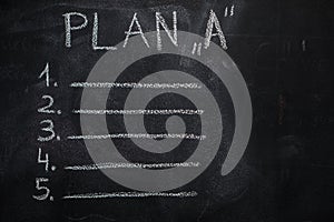 Plan `A` list on black chalkboard