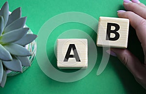Plan A and Plan B. Businessman hand is making a choice between Plan A and Plan B symbol. Beautiful green background with succulent