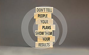 Plan or result symbol. Concept words Do not tell people your plans show them your results on wooden block. Beautiful grey table