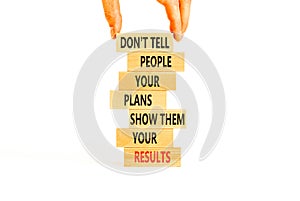 Plan or result symbol. Concept words Do not tell people your plans show them your results on wooden block. Beautiful white table