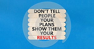 Plan or result symbol. Concept words Do not tell people your plans show them your results on wooden stick on beautiful blue table