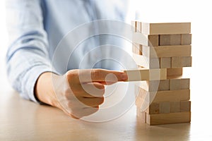Plan and strategy in business, Risk To Make Business Growth Concept With Wooden Blocks, hand of man has piling up and