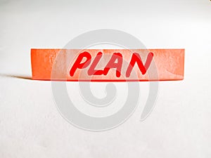 plan text displayed on paperslip on white background