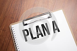plan a text on white paper on the wood table