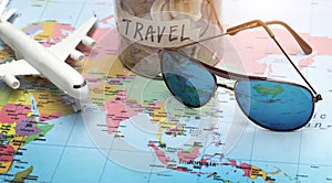 Plan to travel with sunglasses on world map photo