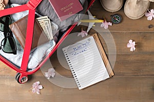 Plan trip on notebook and prepare accessories and travel items