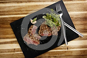 Plan view of Succulent and juicy rare beef steak, with watercress garnish photo