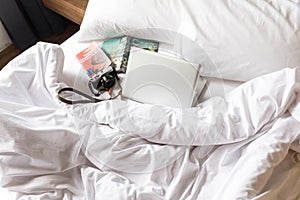 Plan for Your Travel on The Bed with Camera and Guide Books