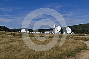Plana Earth Satellite Station or Geodetic Observatory, against the background of coniferous forested hills of Plana mountain