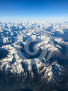 Plane above mountains with exited view through the window