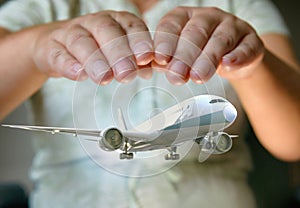 A plane airliner under woman`s hands
