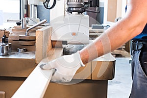 Plane a board on a carpentry machin.