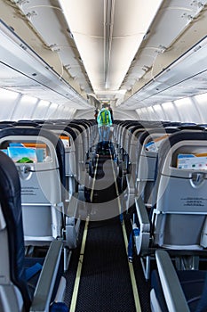 Plane boarding, young adult woman leaving an airplane