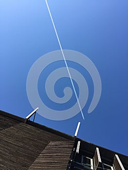Plane clear blue sky building
