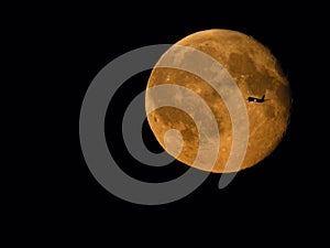 Plane crossing moon