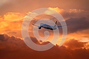 Plane departing at sunset photo