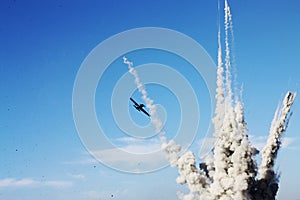 Plane and explosion in the blue sky