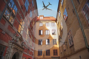 plane flies over the houses of the city over Stockholm.