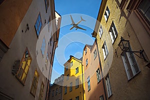 plane flies over the houses of the city over Stockholm.