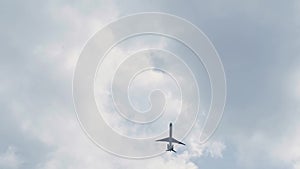 Plane flies in the sky with clouds