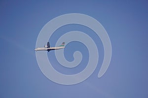 a plane flying against clear blue sky