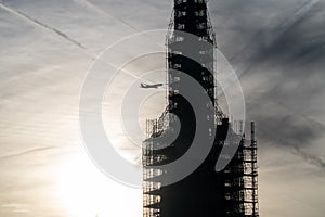 Plane flying into a building under construction