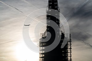 Plane flying into a building under construction