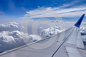 A Plane flying high up amidst clouds