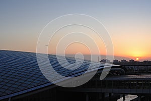 A plane is flying over airport express station