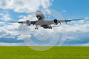 Plane flying over green Meadow on blue Sky with Clouds