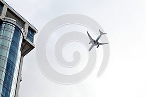 A plane flying over a house -background