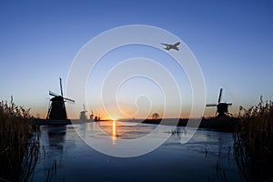 Plane flying over Kinderdijk