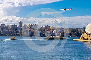 Plane flying over Sydney Harbour Sydney NSW Australia.