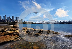 Plane flying over Sydney Harbour Sydney NSW Australia.