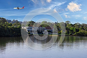 Plane flying over Sydney Harbour Sydney NSW Australia.