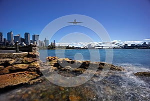 Plane flying over Sydney Harbour Sydney NSW Australia.