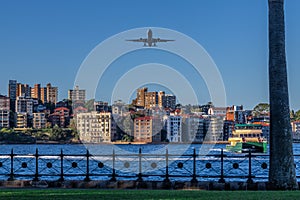 Plane flying over Sydney Harbour Sydney NSW Australia.