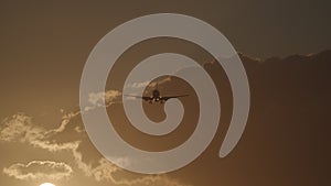 Plane flying in sky with warm evening light