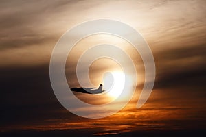 plane flying at sun in sunset sky. airplane in the air. transportation concept with space for text. Silhouette of a big